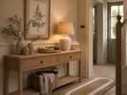 Narrow wooden console table with decorative items in a home interior setting.